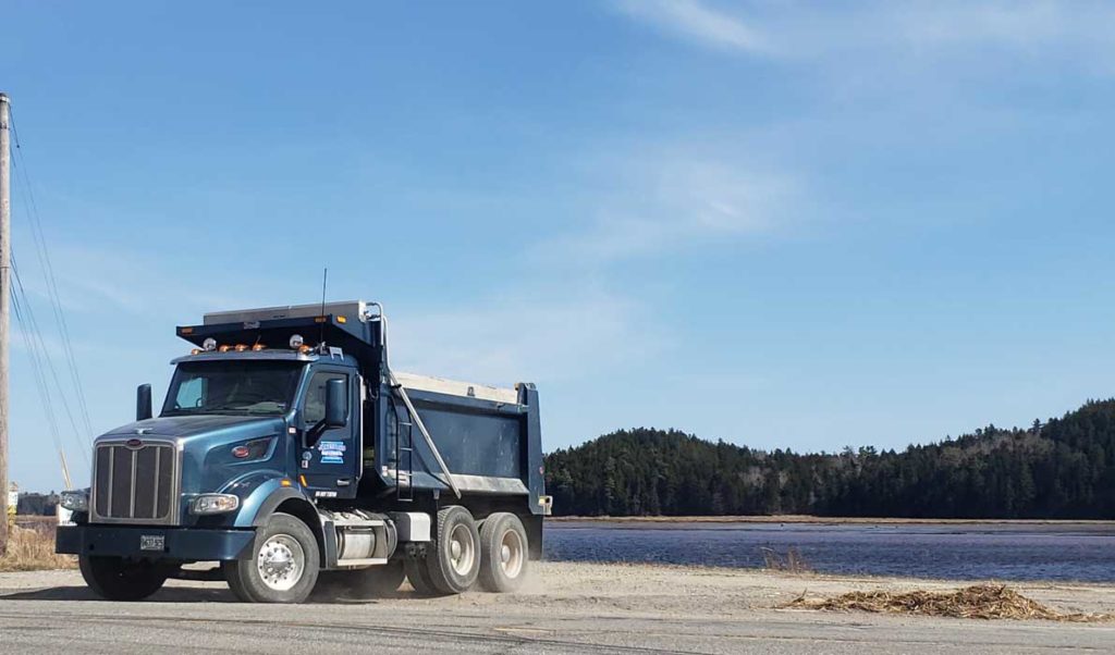 A Maine Department of Transportation dump truck pulls off of the Downeast Sunrise Trail