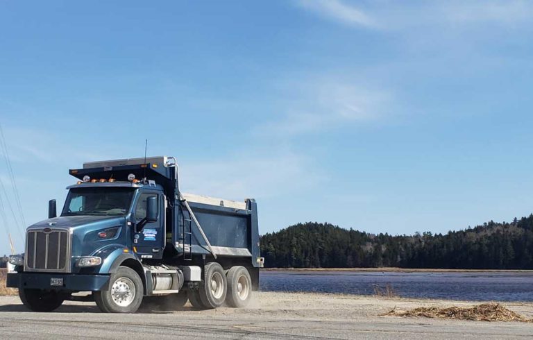 A Maine Department of Transportation dump truck pulls off of the Downeast Sunrise Trail