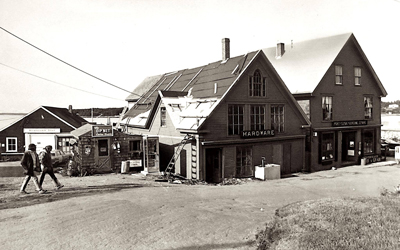 An image from the 1960s or 1970s, with the Monhegan Boat Lines office seen at left.