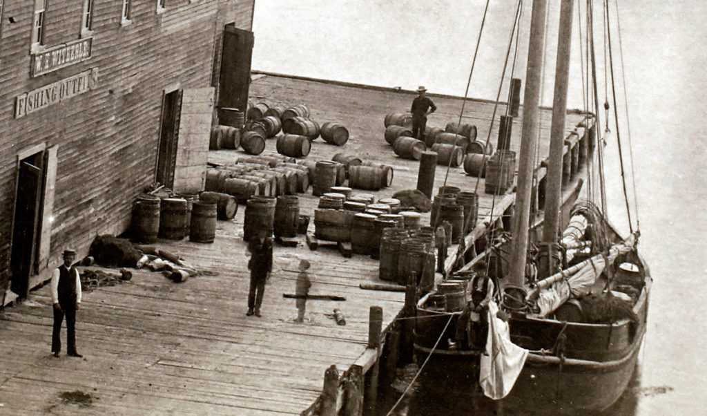 The W. H. Witherle & Co. dock and salt storage building in Castine. Research suggests the casks are filled with salt. PHOTO: COURTESY NEW ENGLAND HISTORIC GENEALOGICAL SOCIETY