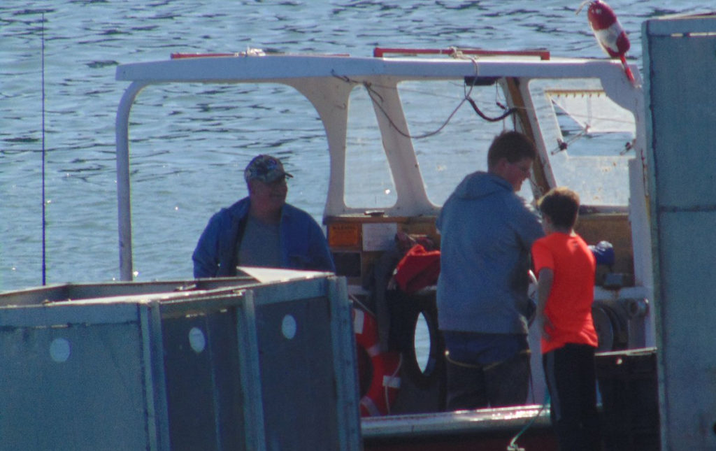 Ryan Murphy hands out cards explaining how to turn on the Libby Island fog horn.