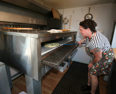 Emily Damon opened Island Takeaway in Town Hill as an affordable location to prepare her gourmet pizza and other items.