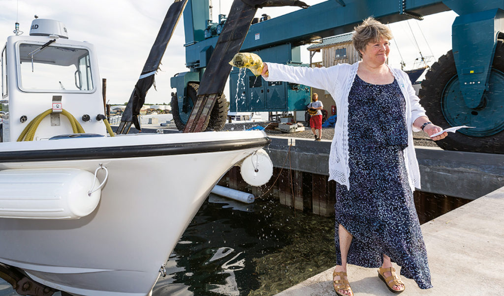 Capt. Pam Parker of the Maine Department of Environmental Protection christens Friends of Casco Bay’s new pump-out boat.