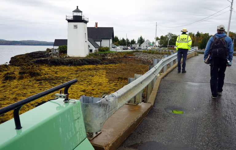 A crew member and passenger walk off the ferry to Islesboro.