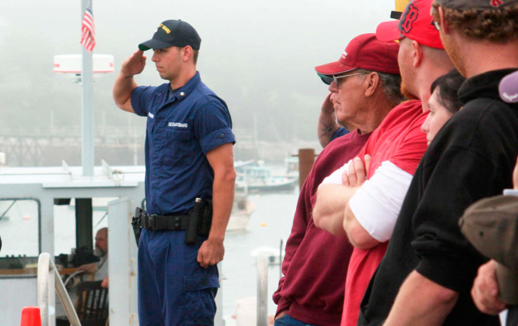 A Coast Guardsman salutes during 2011 ceremonies in Bass Harbor to commemorate mariners lost at sea.