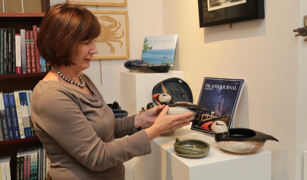 Archipelago's assistant manager Frances Holdgate shows off Richard Robertson's ceramic work.