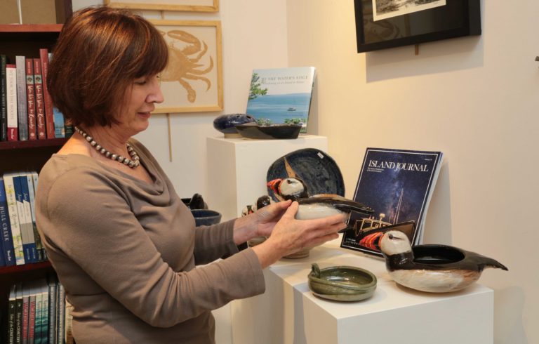 Archipelago's assistant manager Frances Holdgate shows off Richard Robertson's ceramic work.