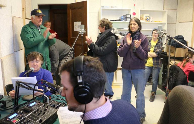 Volunteers and supporters celebrate WBFY/100.9 FM going on-air.