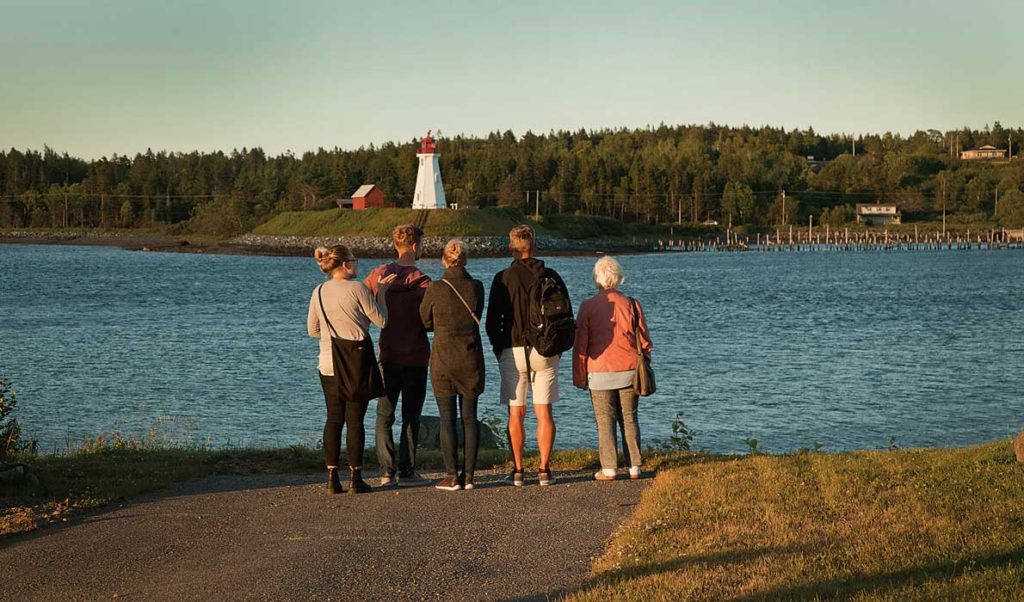 Visitors to Lubec look across the narrows that connects Cobscook Bay with the Atlantic Ocean and marks the international border. Mulholland Light is on Campobello Island in Canada.