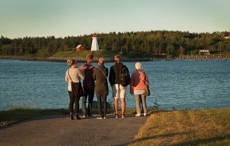 Visitors to Lubec look across the narrows that connects Cobscook Bay with the Atlantic Ocean and marks the international border. Mulholland Light is on Campobello Island in Canada.