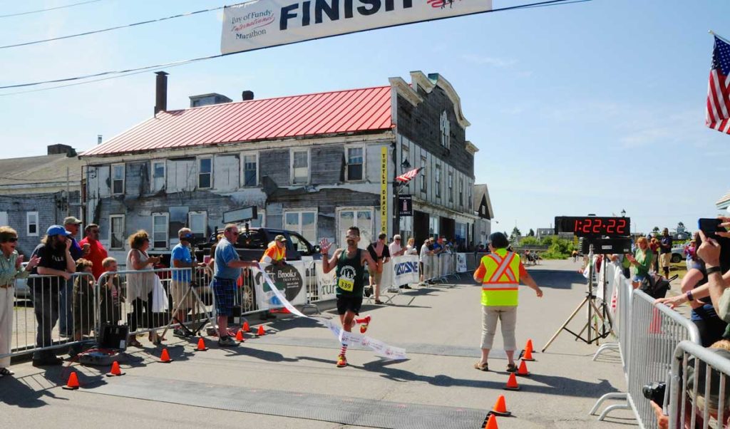 A runner crosses the finish line in Lubec.