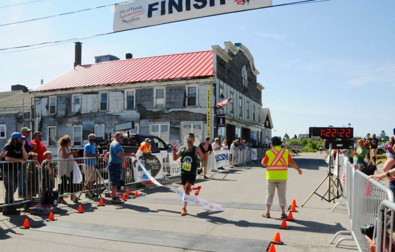 A runner crosses the finish line in Lubec.