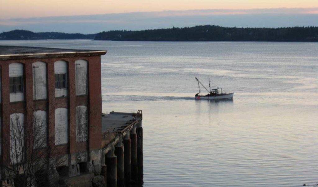 A fishing boat heads out at dawn in December from Eastport.