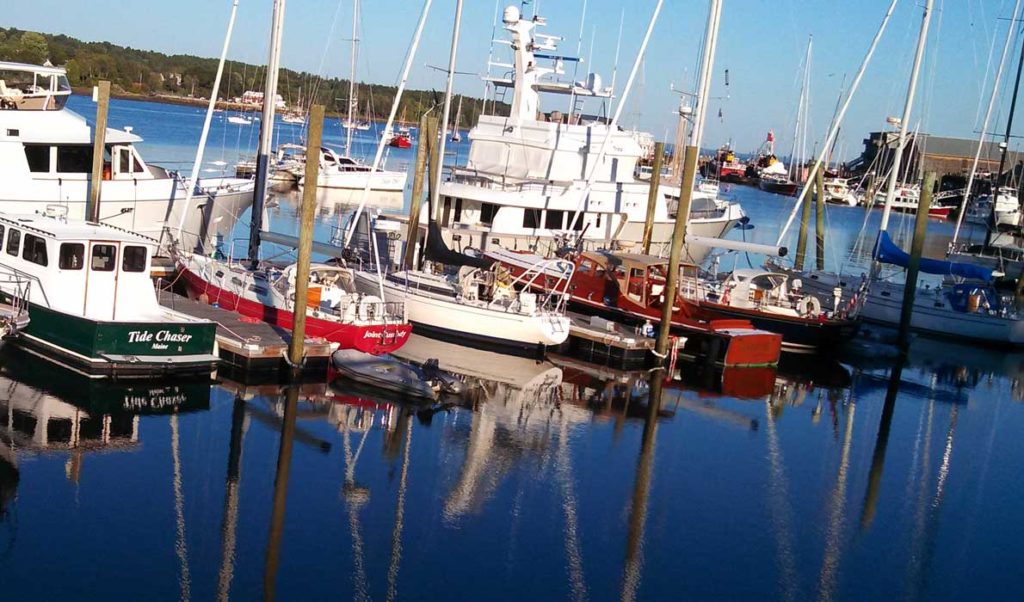 The late afternoon sun illuminates boats in Front Street Shipyard's marina on Belfast Harbor.