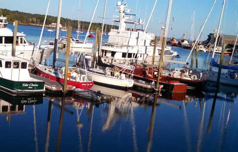 The late afternoon sun illuminates boats in Front Street Shipyard's marina on Belfast Harbor.