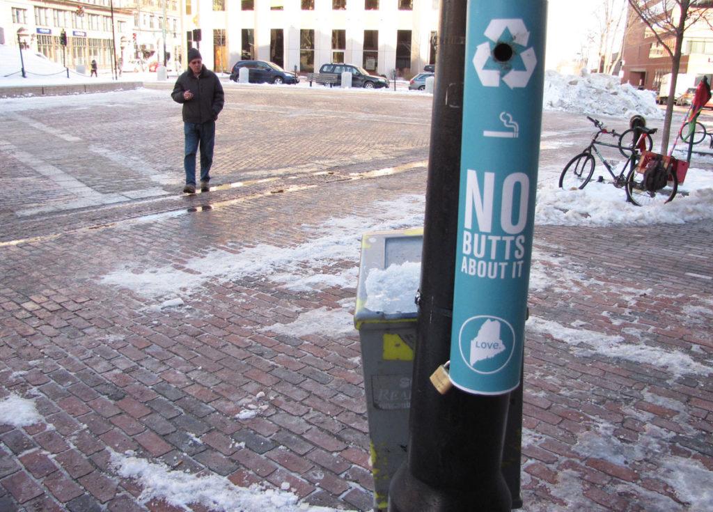 A smoker approaches the "Buttler" in Monument Square.