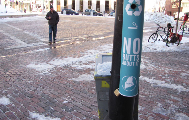 A smoker approaches the "Buttler" in Monument Square.