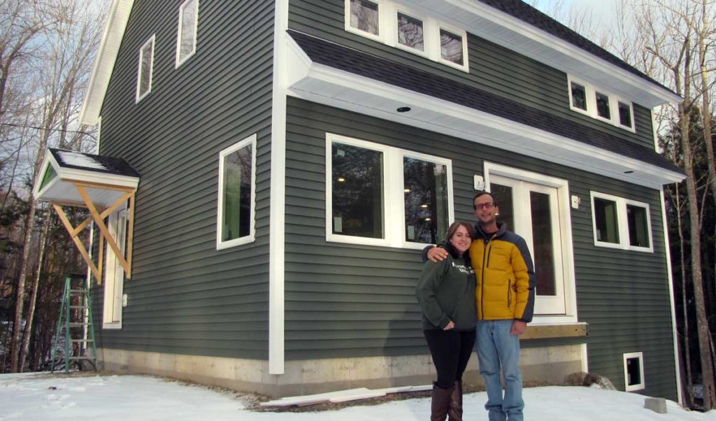 Megan and Keaton Scarponi in front of their soon-to-be-completed new house in Washington.