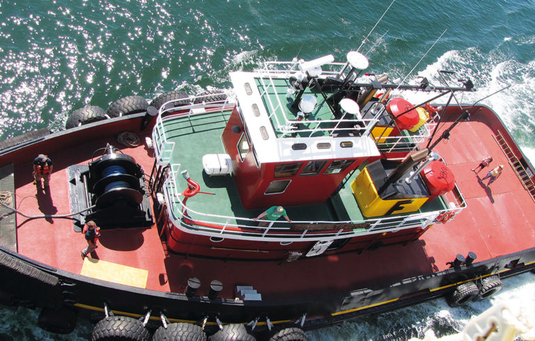 One of Fournier's tugs works alongside Maine Maritime Academy's State of Maine last summer.