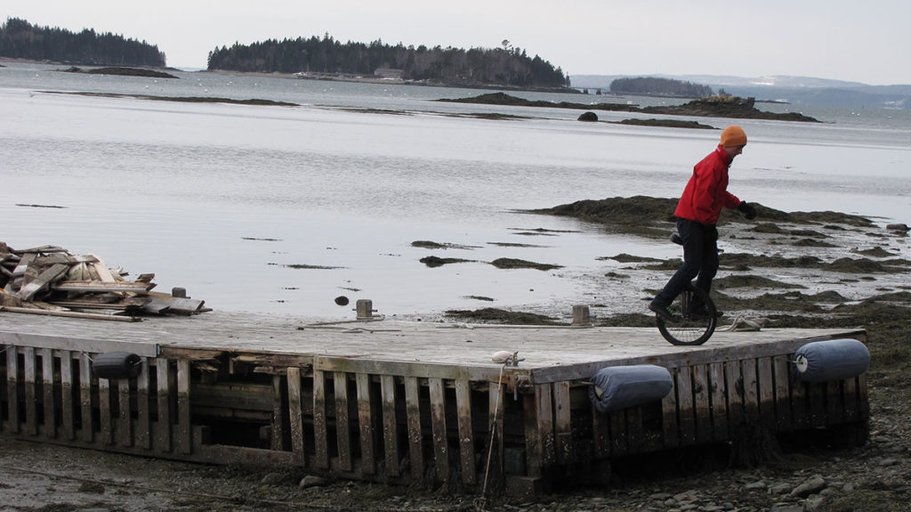 Ryan Murphy unicycles at the Dark Harbor Boat Yard on Islesboro.