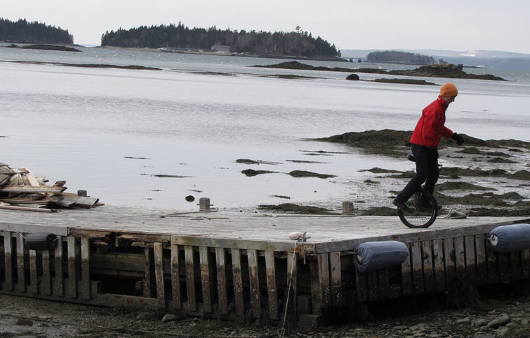 Ryan Murphy unicycles at the Dark Harbor Boat Yard on Islesboro.