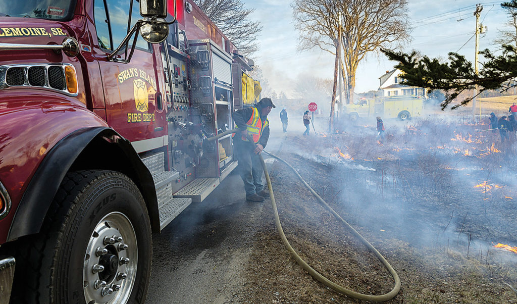 Volunteers work at burning fields on Swan's Island.