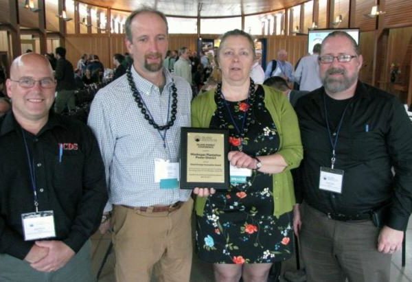 Marian Chioffi and Chris Smith of the Monhegan Plantation Power District (center) with representatives of Innovative Construction & Design Solutions