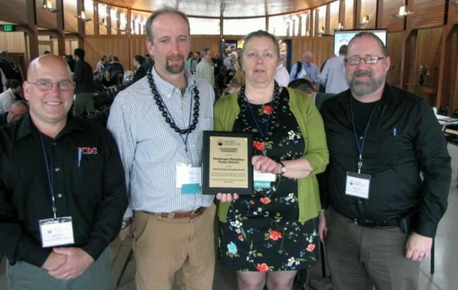 Marian Chioffi and Chris Smith of the Monhegan Plantation Power District (center) with representatives of Innovative Construction & Design Solutions