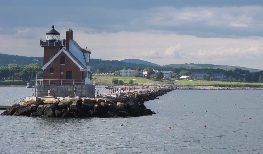 Tourists enjoy a stroll on Rockland's breakwater in late July.