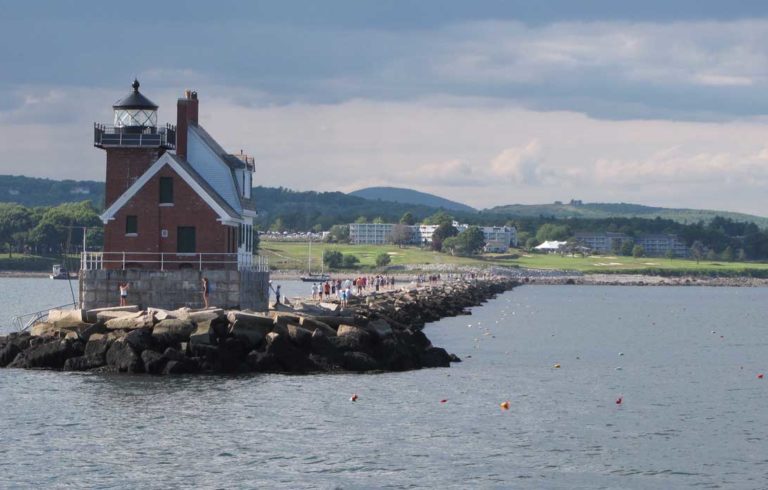 Tourists enjoy a stroll on Rockland's breakwater in late July.