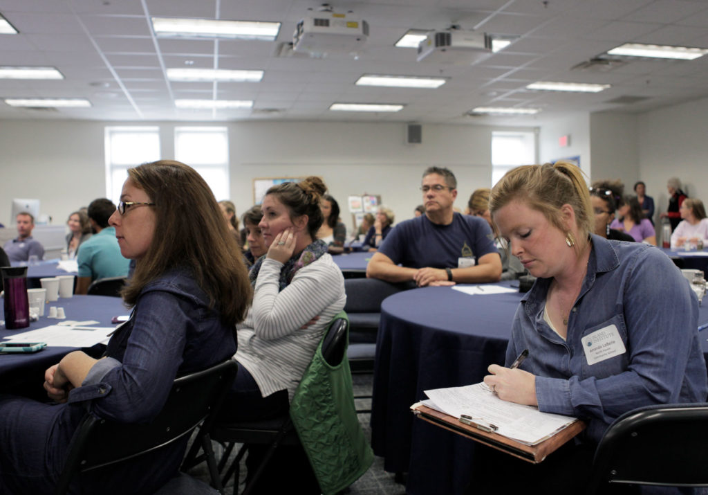 Participants listen and take notes during a presentation at the 2017 Island Teachers Conference