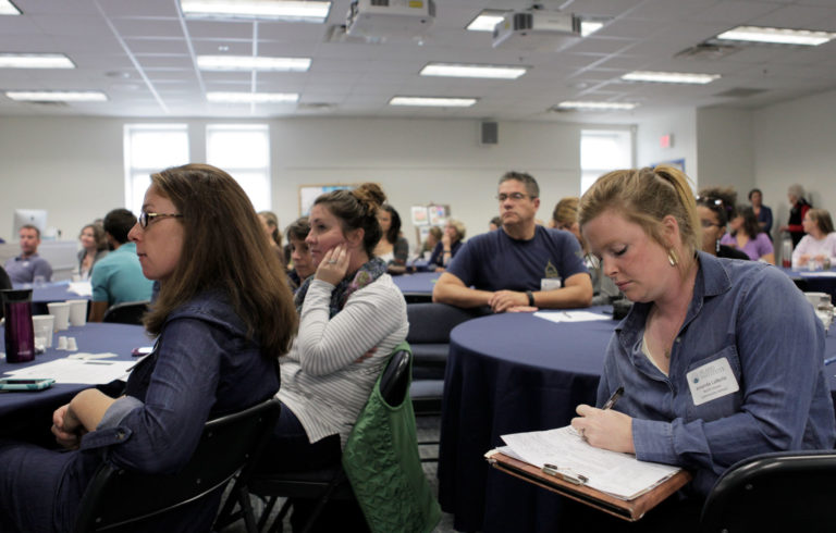 Participants listen and take notes during a presentation at the 2017 Island Teachers Conference
