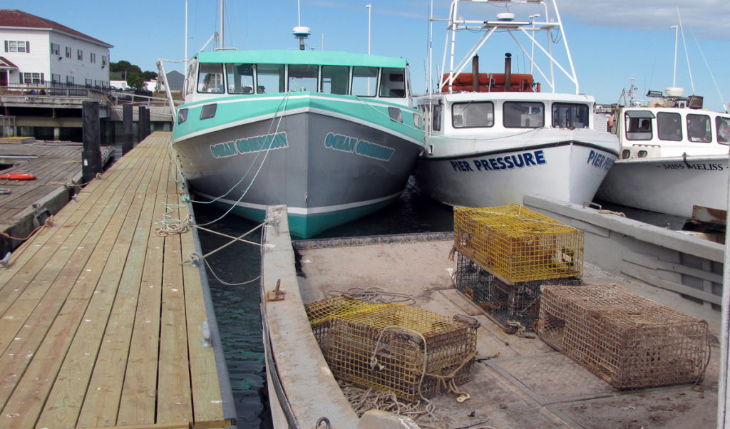 Lobster boats docked inside Eastport’s breakwater. Lobstermen throughout Maine now face a trade hurdle their Canadian counterparts do not.