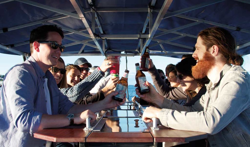 Pedalers on the foot-powered Maine Baycycle enjoy their beverages.