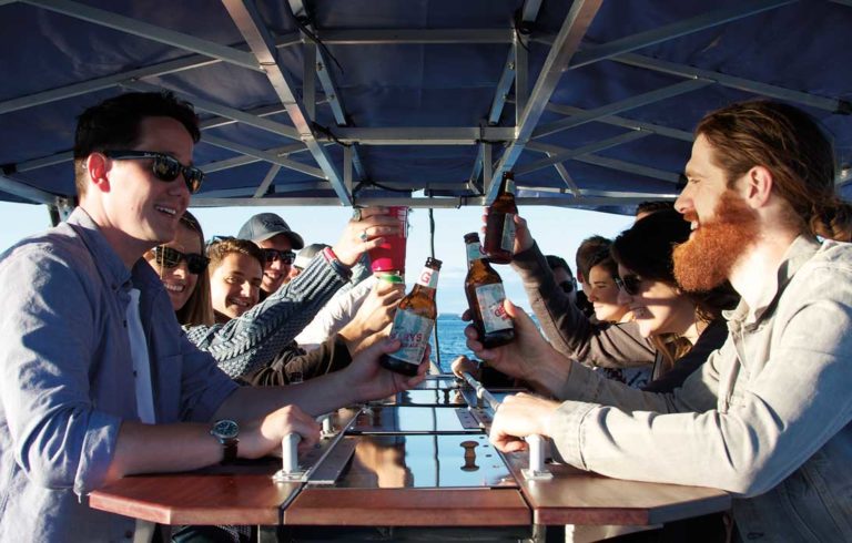 Pedalers on the foot-powered Maine Baycycle enjoy their beverages.