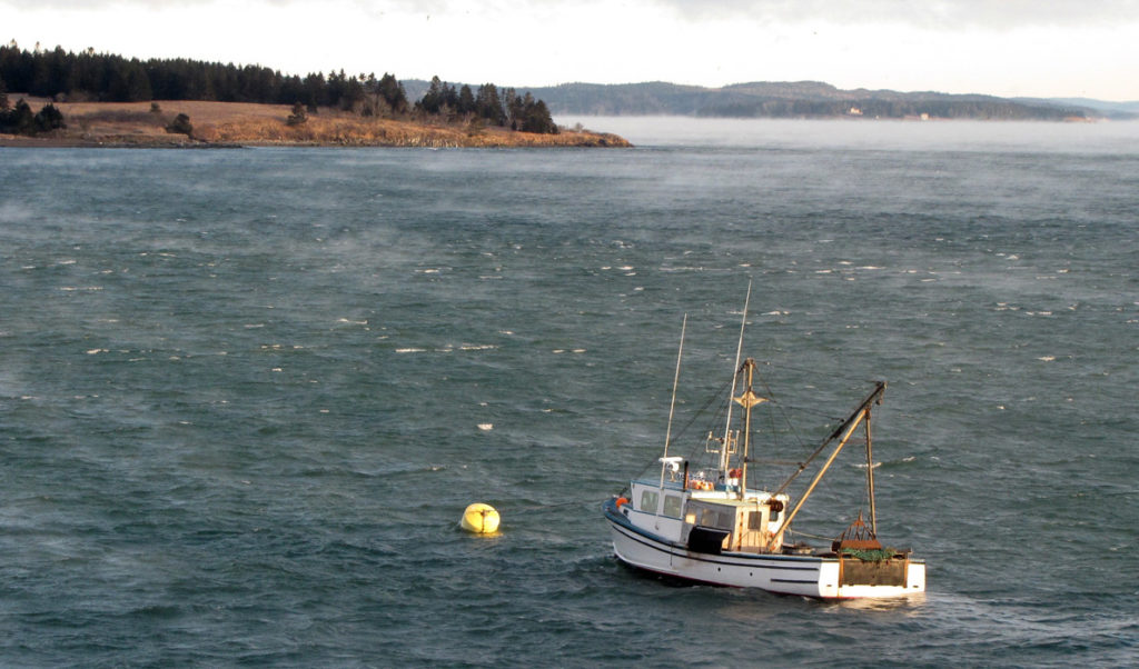 A scallop dragger at its mooring on a cold