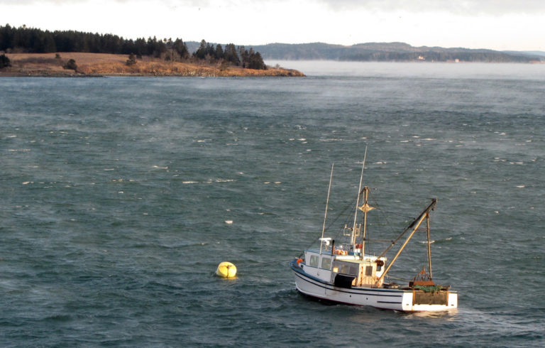 A scallop dragger at its mooring on a cold