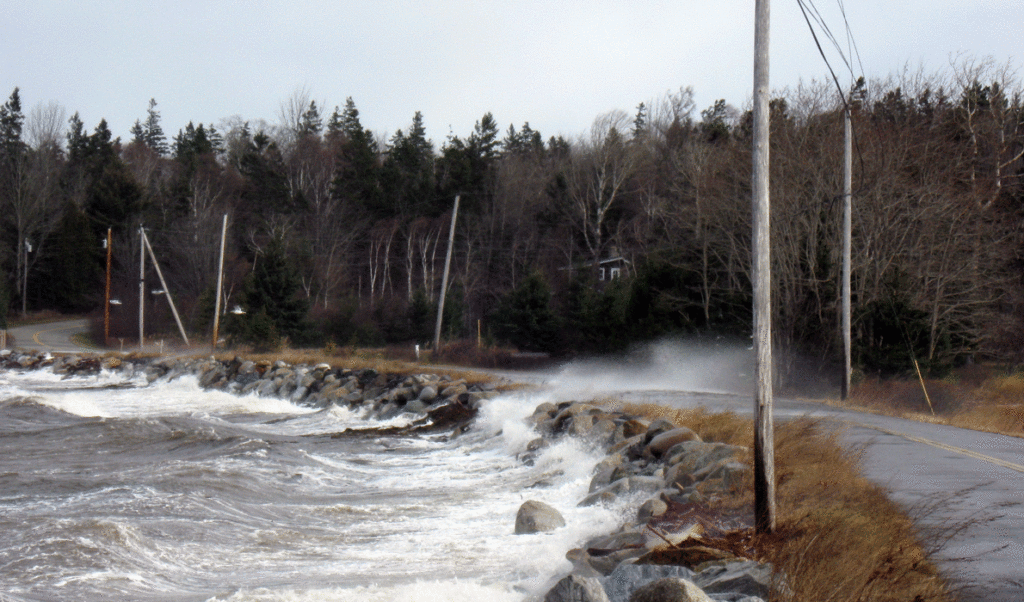 Seas break over the main road on Islesboro in the area known as the Narrows.