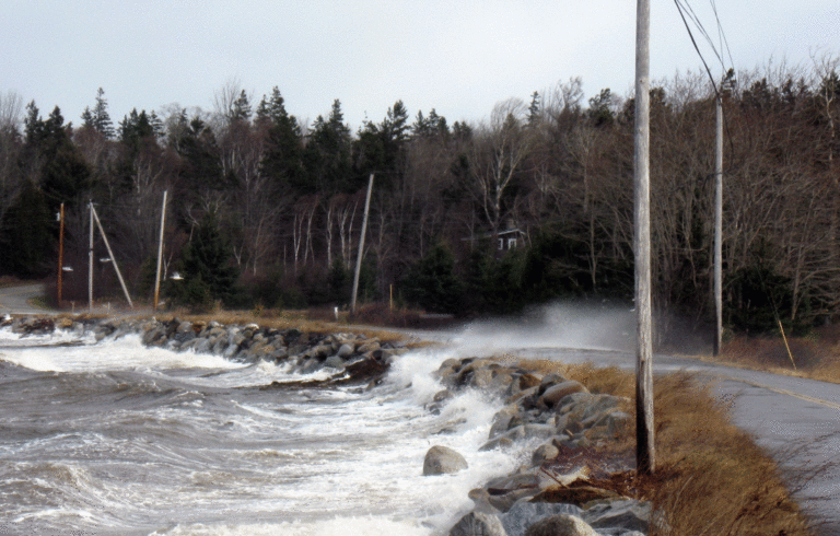Seas break over the main road on Islesboro in the area known as the Narrows.