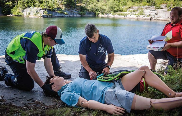 Emergency response volunteers practice with a mannequin on Vinalhaven.