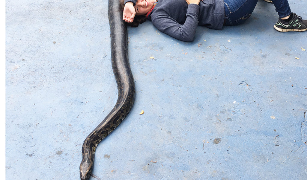 Andrea Shane poses with one of her patients at the Antigua Exotic rescue center in Antigua