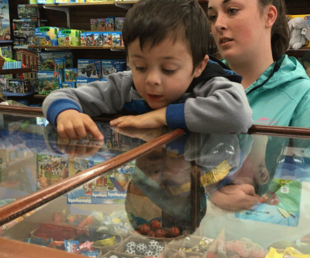 Corbin Davis peers through the glass counter to make his choice.