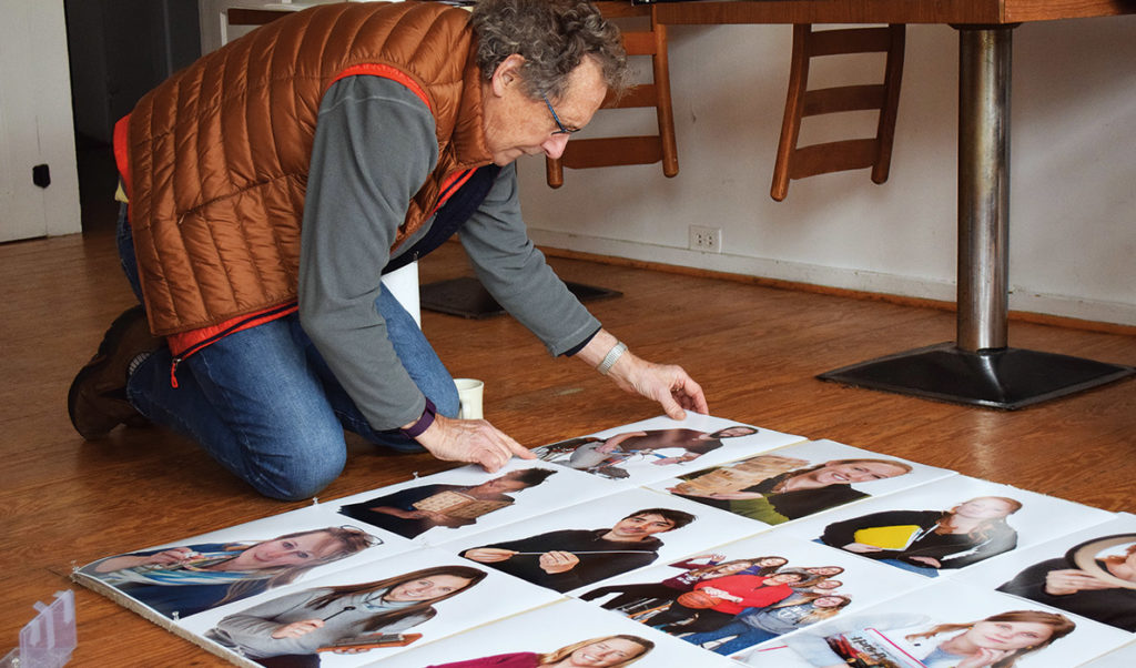 Richard Howard examining his photos of Vinalhaven residents.