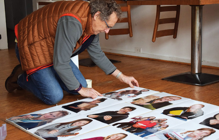 Richard Howard examining his photos of Vinalhaven residents.