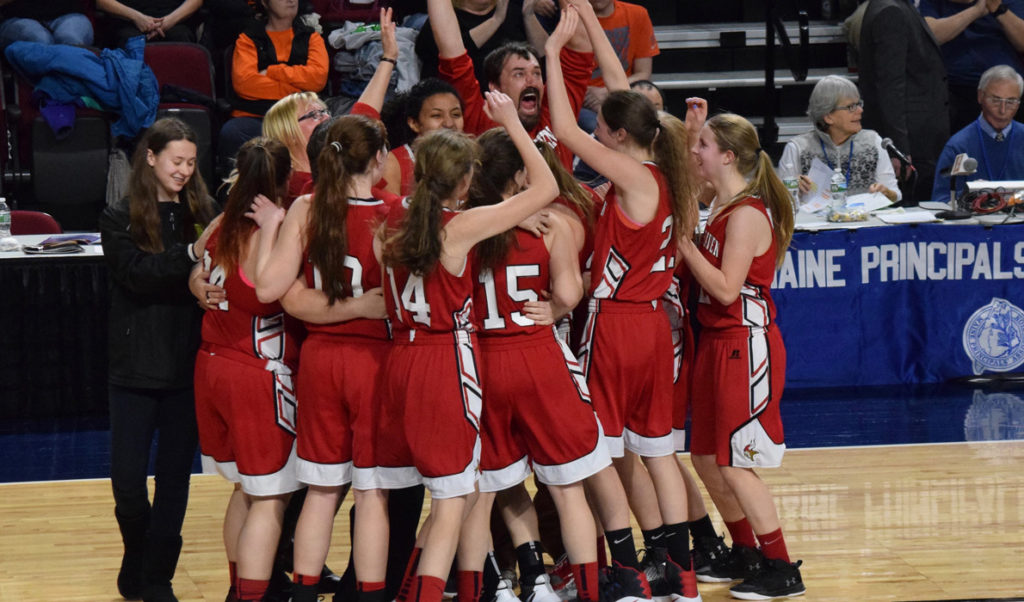 The Vinalhaven Vikings girls basketball team celebrates its Class D state championship in Bangor on Friday