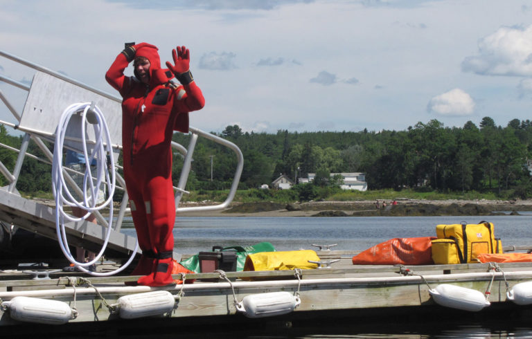 Demonstrating an immersion suit.