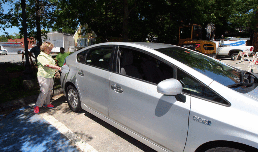 Diane Blanchette takes the first charge from Ellsworth’s new electric vehicle charger