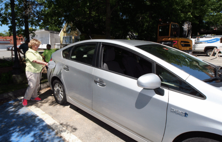 Diane Blanchette takes the first charge from Ellsworth’s new electric vehicle charger