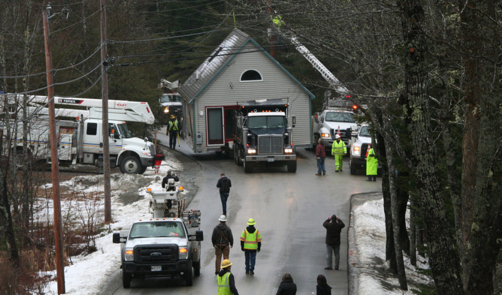 A house donated to Island Housing Trust is moved to a new property in Somesville to provide affordable housing.