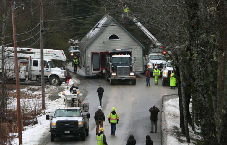 A house donated to Island Housing Trust is moved to a new property in Somesville to provide affordable housing.